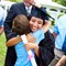 A happy graduate hugs a young boy